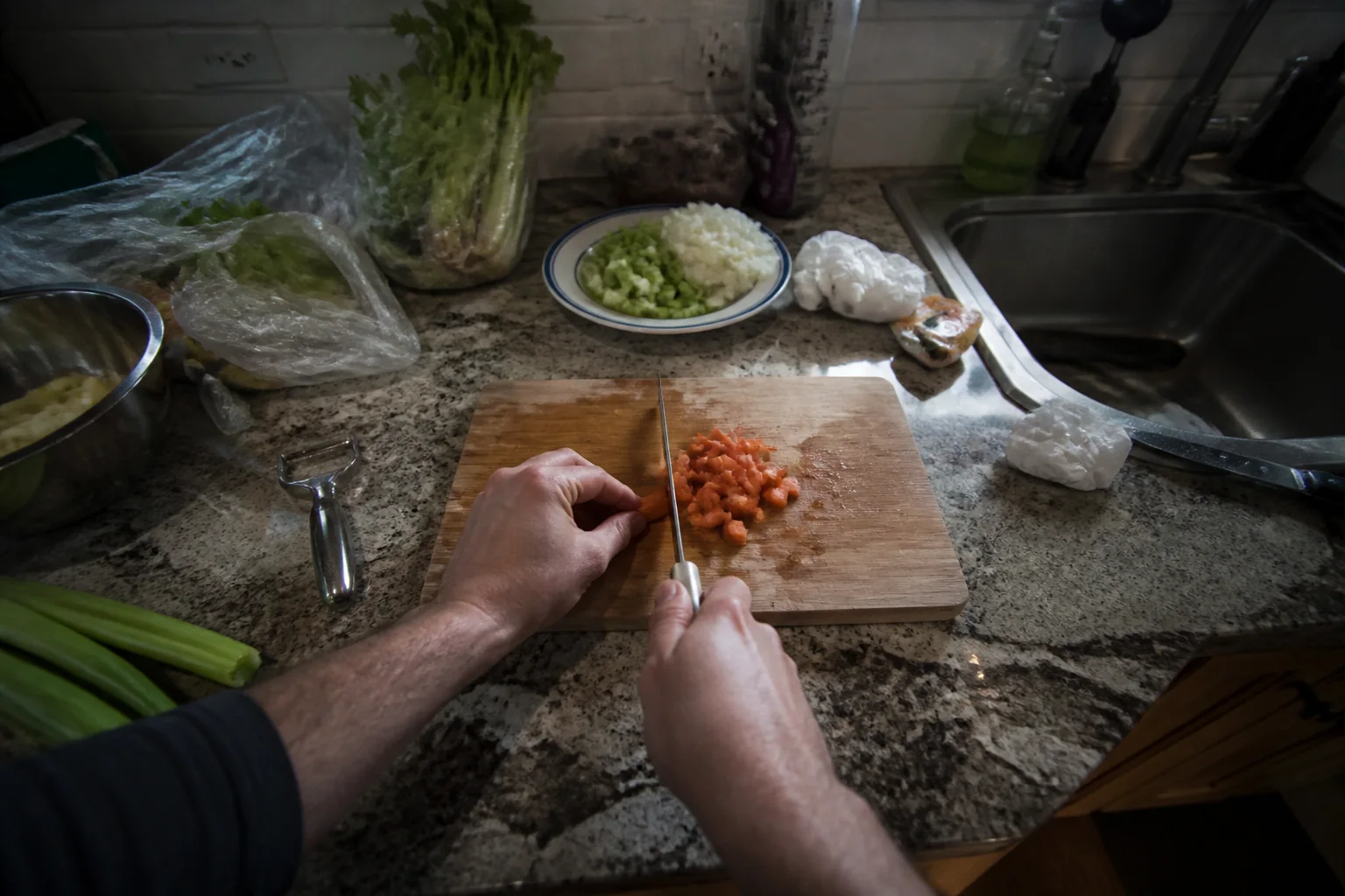 Egocentric view of hands cooking in a home kitchen